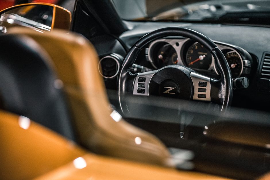 Inside of shiny modern expensive prestige sport automobile with steering wheel and dashboard